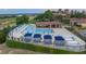 Community pool area with lounge chairs, cabanas, and shaded seating in outdoor pavilion at 16112 Vetta Dr, Montverde, FL 34756