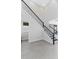Modern staircase with black metal railings and white walls, leading to the upper level at 16112 Vetta Dr, Montverde, FL 34756