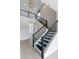 Interior view of a modern staircase with black metal railings and tile flooring at 16112 Vetta Dr, Montverde, FL 34756