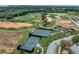 Aerial view of the community's well-maintained tennis courts surrounded by lush landscaping at 16112 Vetta Dr, Montverde, FL 34756