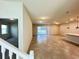 Open-concept living room with a view of stairs and a sliding door to the screened-in lanai at 16380 Saint Kitts Circle, Clermont, FL 34714