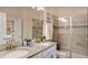 Elegant bathroom featuring double sinks, granite countertops and a glass-enclosed shower at 1656 Moon Valley Dr, Davenport, FL 33896