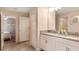 Bright bathroom boasts dual sinks, framed art, and access to an attached bedroom at 1656 Moon Valley Dr, Davenport, FL 33896