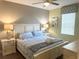 Cozy bedroom with neutral walls features coordinated bedding, lamps, and a ceiling fan at 1656 Moon Valley Dr, Davenport, FL 33896