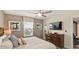 Calming bedroom with a large window, ceiling fan, flatscreen tv, and dresser at 1656 Moon Valley Dr, Davenport, FL 33896