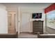 This bedroom features a flatscreen tv, a dresser, and a closet for ample storage at 1656 Moon Valley Dr, Davenport, FL 33896
