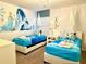 Themed bedroom with twin beds and unique Frozen-inspired artwork at 1656 Moon Valley Dr, Davenport, FL 33896