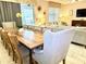 Inviting dining room with a large table, comfortable seating, and view into the living room at 1656 Moon Valley Dr, Davenport, FL 33896