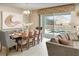 Dining area with an elegant dining table and chairs is open to a cozy Gathering room with pool views at 1656 Moon Valley Dr, Davenport, FL 33896