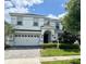 Charming two-story home with landscaped yard, two car garage and paved driveway at 1656 Moon Valley Dr, Davenport, FL 33896