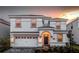 Two-story home featuring a two-car garage and an arched entryway at 1656 Moon Valley Dr, Davenport, FL 33896