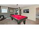 A vibrant game room boasts a pool table, television, and comfortable seating for ultimate relaxation at 1656 Moon Valley Dr, Davenport, FL 33896