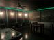 Finished game room offers foosball, air hockey, and video game area with dimmable lights and black ceilings at 1656 Moon Valley Dr, Davenport, FL 33896