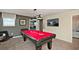 Bright game room featuring a billiards table, carpet, and a flat screen television at 1656 Moon Valley Dr, Davenport, FL 33896