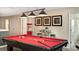 Open game room featuring a billiards table, sleek furniture, carpet and pendant lighting at 1656 Moon Valley Dr, Davenport, FL 33896