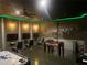 Finished basement game room with air hockey, foosball, wall-mounted screens, and custom military themed artwork at 1656 Moon Valley Dr, Davenport, FL 33896