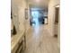 Bright hallway leads to the home's open living area, showcasing the neutral color palette at 1656 Moon Valley Dr, Davenport, FL 33896
