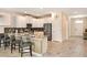 Modern kitchen featuring white cabinets, stainless steel appliances, granite countertops, and bar stool seating at 1656 Moon Valley Dr, Davenport, FL 33896