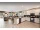 Modern kitchen with stainless steel appliances and white cabinets overlooking the living room at 1656 Moon Valley Dr, Davenport, FL 33896