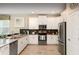 Contemporary kitchen featuring sleek white cabinets, stainless steel appliances, and modern fixtures at 1656 Moon Valley Dr, Davenport, FL 33896