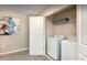 Convenient laundry room with side-by-side washer and dryer and storage shelves at 1656 Moon Valley Dr, Davenport, FL 33896
