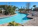 A winding lazy river surrounded by tropical landscaping and lounge chairs at 1656 Moon Valley Dr, Davenport, FL 33896