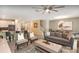 Open concept living room featuring neutral tones, modern furnishings, and a view to kitchen and dining area at 1656 Moon Valley Dr, Davenport, FL 33896