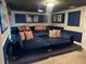 Home theater with a projector, movie screen, stylish decor, and comfortable furniture at 1656 Moon Valley Dr, Davenport, FL 33896