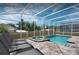 Relax by the screened pool and spa area, complete with lounge chairs and a private backyard setting at 1656 Moon Valley Dr, Davenport, FL 33896