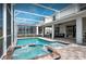 The screened-in pool and spa are highlights of the outdoor space with the house's patio in the background at 1656 Moon Valley Dr, Davenport, FL 33896