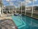 A serene screened pool area features a pool and spa with lounge seating, and privacy for relaxation and enjoyment at 1656 Moon Valley Dr, Davenport, FL 33896