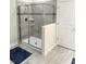 Tiled walk-in shower with glass enclosure, built-in shelves, and modern fixtures at 1656 Moon Valley Dr, Davenport, FL 33896