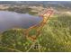 Aerial view of lot outlined in red, backing up to tranquil lake with mature trees at 1680 Blackwelder Rd, De Leon Springs, FL 32130