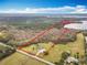 Expansive aerial view of a large lot home with a backdrop of lush trees and a lake at 1680 Blackwelder Rd, De Leon Springs, FL 32130