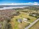 An aerial view shows a home with a large lot near a wooded area and lake at 1680 Blackwelder Rd, De Leon Springs, FL 32130