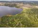 Overhead view of forested area, including a natural lake and walking trails at 1680 Blackwelder Rd, De Leon Springs, FL 32130