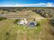 Expansive property with a home, barn, and a pool, all set within a large, grassy landscape with mature trees at 1680 Blackwelder Rd, De Leon Springs, FL 32130
