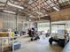 Spacious barn interior featuring a variety of tools, equipment, with large open door to the outside at 1680 Blackwelder Rd, De Leon Springs, FL 32130