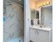 Elegant bathroom featuring a beautifully tiled shower with modern fixtures and white vanity at 1680 Blackwelder Rd, De Leon Springs, FL 32130