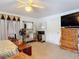 Spacious bedroom featuring ample furniture, a ceiling fan, and comfortable carpet flooring at 1680 Blackwelder Rd, De Leon Springs, FL 32130