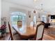 Inviting dining room featuring wood floors and trim, with a view to the large front yard at 1680 Blackwelder Rd, De Leon Springs, FL 32130