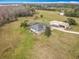 Aerial view of home with screened pool, work shed, and expansive yard at 1680 Blackwelder Rd, De Leon Springs, FL 32130