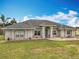 Traditional brick home featuring a manicured lawn, mature landscaping and welcoming entry at 1680 Blackwelder Rd, De Leon Springs, FL 32130