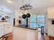Bright kitchen features an island cooktop, stainless appliances, and an adjacent pool view through sliding glass doors at 1680 Blackwelder Rd, De Leon Springs, FL 32130
