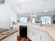 Bright kitchen features white cabinets, countertops, a breakfast bar, and opens to the living room at 1680 Blackwelder Rd, De Leon Springs, FL 32130
