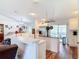 Open concept kitchen with stainless steel appliances, white cabinetry and a large island at 1680 Blackwelder Rd, De Leon Springs, FL 32130