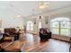 Bright living room boasts wood floors, tray ceilings, and natural light from large windows at 1680 Blackwelder Rd, De Leon Springs, FL 32130