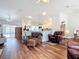 Spacious living room with an open floor plan, wood floors, and views of the kitchen at 1680 Blackwelder Rd, De Leon Springs, FL 32130