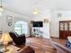 Open living room featuring vaulted ceilings, a ceiling fan, wood floors, and large windows at 1680 Blackwelder Rd, De Leon Springs, FL 32130