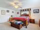 Spacious main bedroom featuring a four-poster bed, decorative accents, and comfortable carpet flooring at 1680 Blackwelder Rd, De Leon Springs, FL 32130